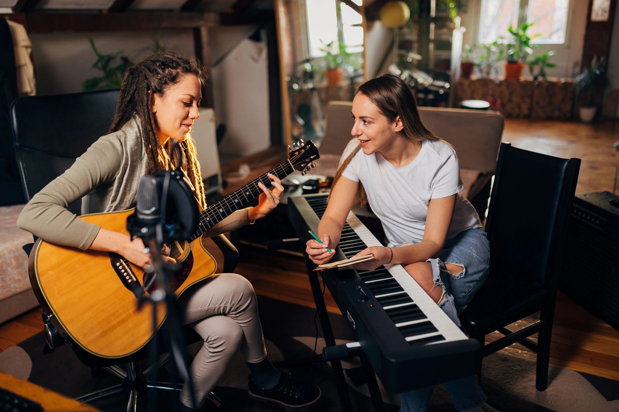 Hands writing music notes in a studio